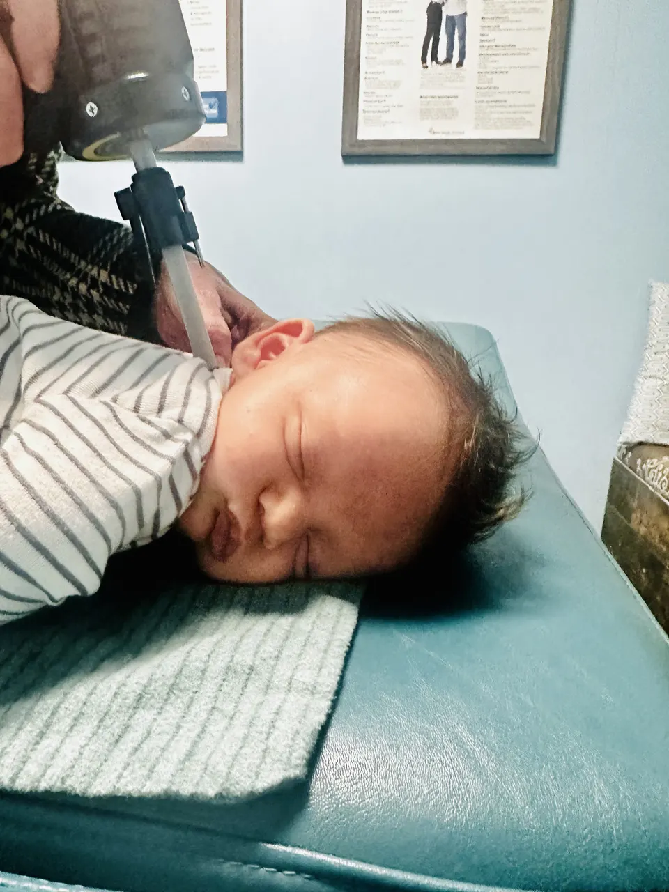 Dr. Anna Saylor gently adjusting a sleeping newborn
