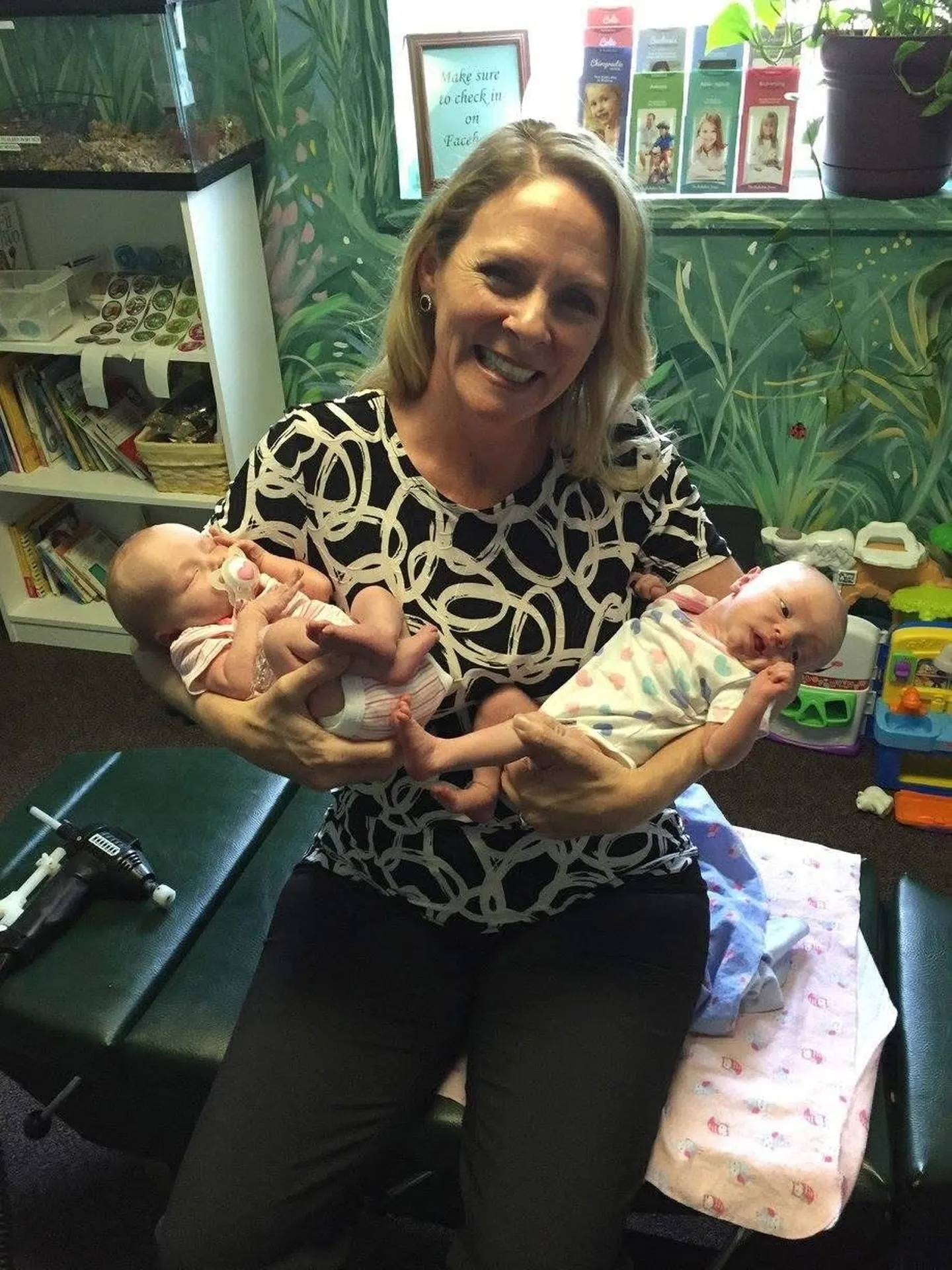 Dr. Anna Saylor holding twin newborns