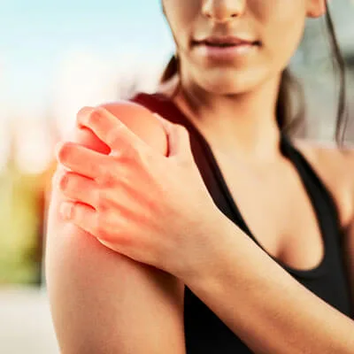 person holding shoulder in pain