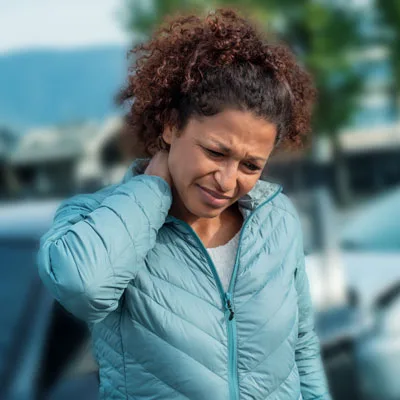 woman holding neck in pain