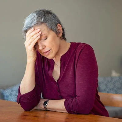 person looking tired sitting at a table