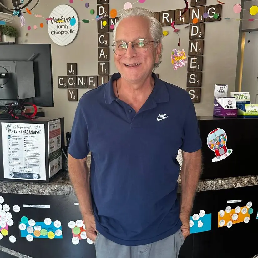 Dr. John Johr smiling at the Van Every front desk
