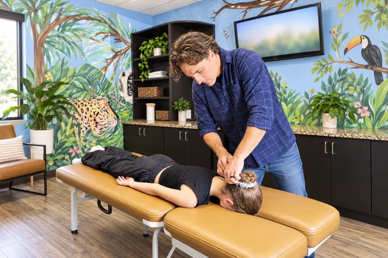 Dr. Zach Conner giving a gentle adjustment to a young patient