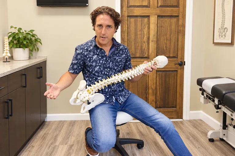 Dr. Zach Conner teaching with a spine model